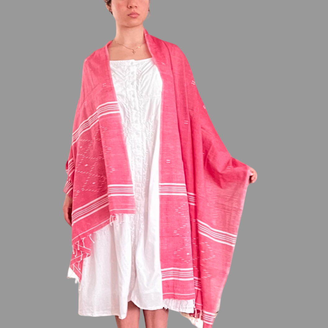 Woman wearing a pink cotton scarf and white striped and diamond Jamdani patterns
