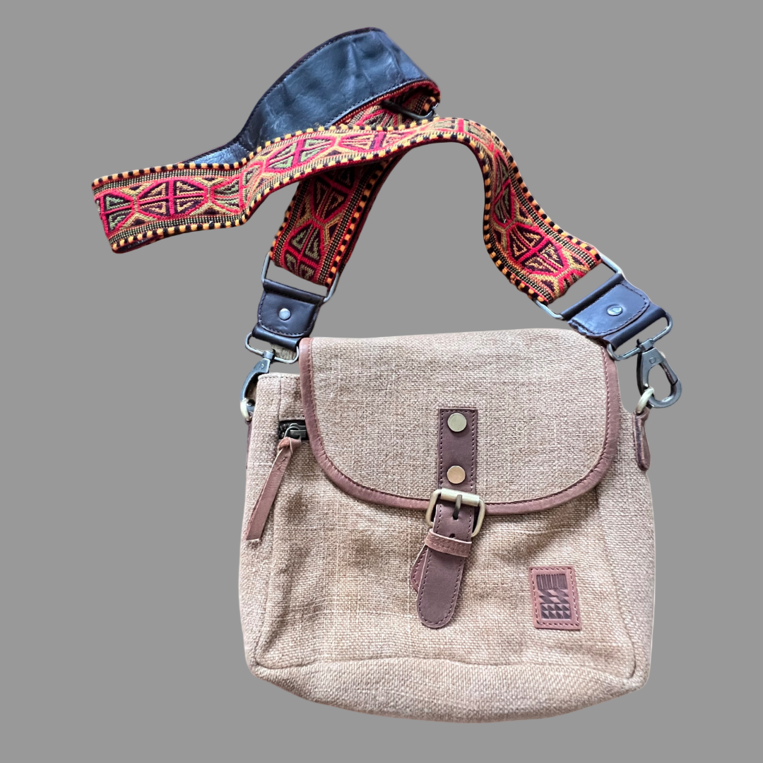 Decorative handmade crossbody bag strap with geometric pattern with leather backing with a camel bag