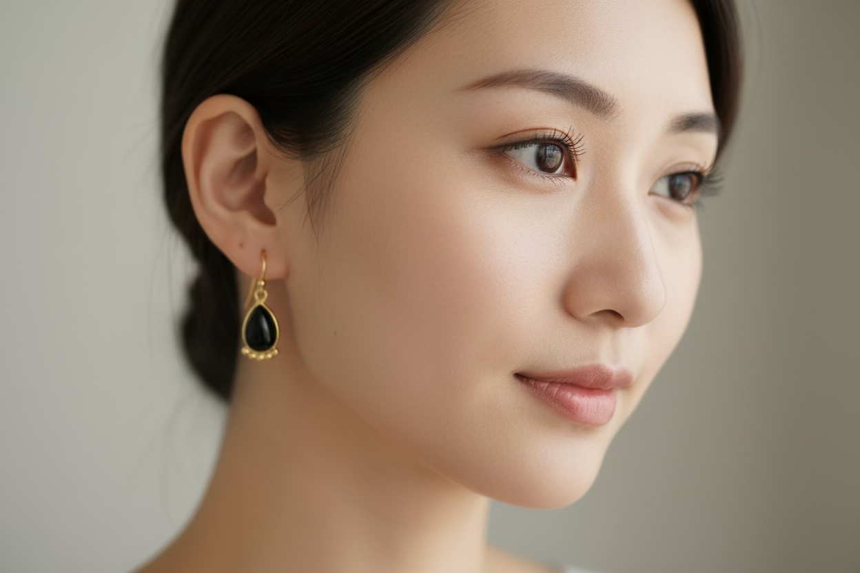 Black onyx gold plated earrings on asian woman