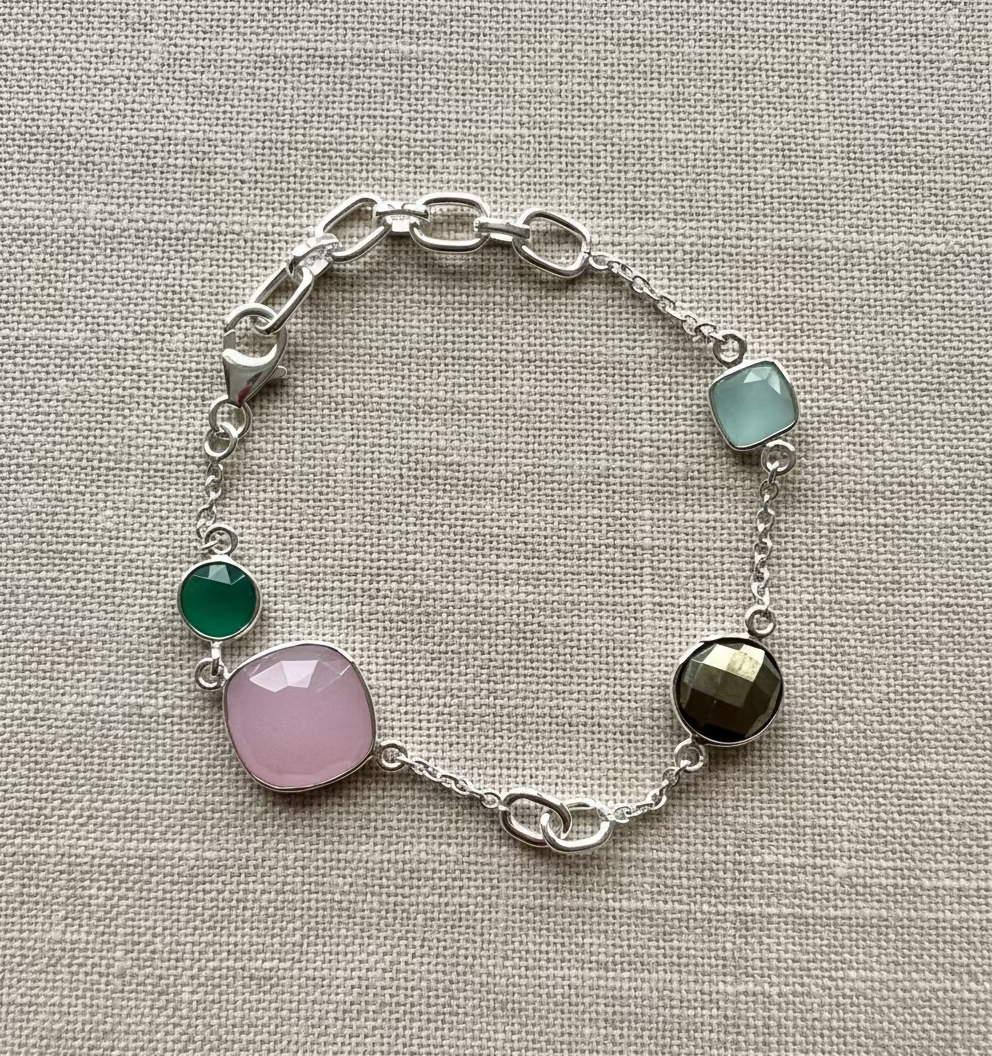Silver bracelet with colorful gemstones on a light gray background